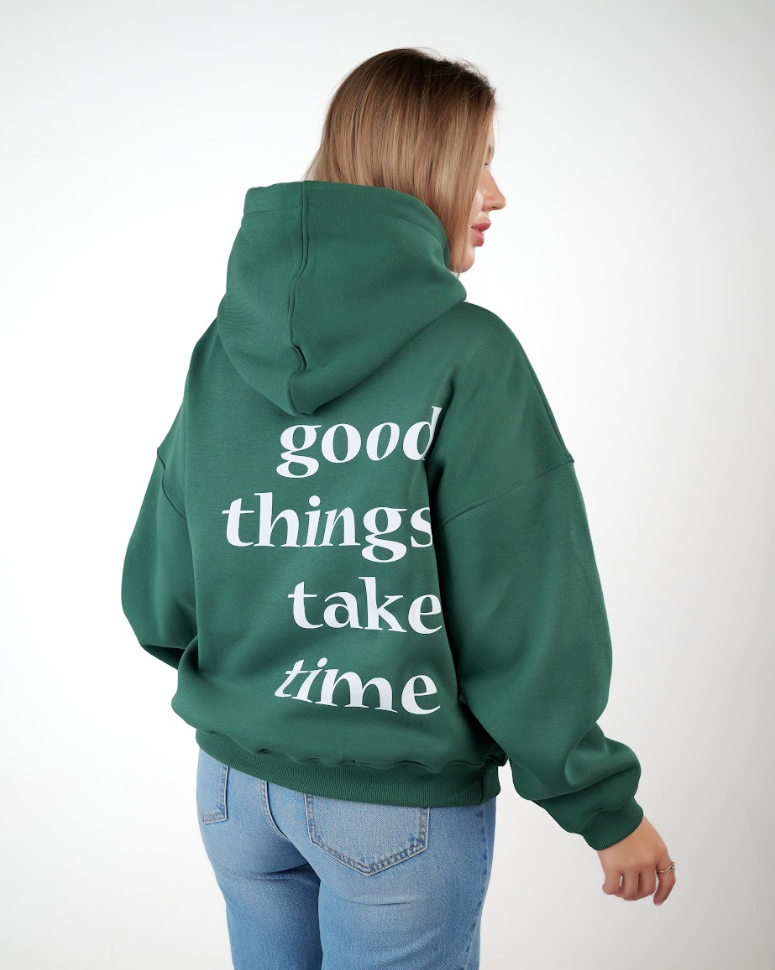 “Front logo, back inspiration — Ezi green sweatshirt.”