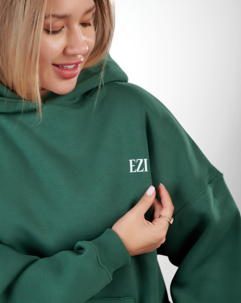 “Front logo, back inspiration — Ezi green sweatshirt.”