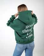 “Front logo, back inspiration — Ezi green sweatshirt.”