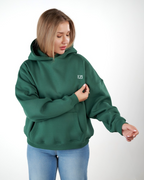 “Front logo, back inspiration — Ezi green sweatshirt.”