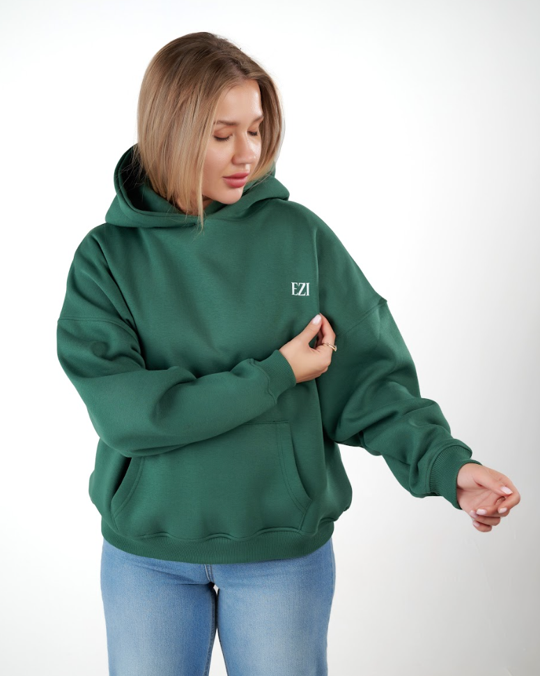 “Front logo, back inspiration — Ezi green sweatshirt.”