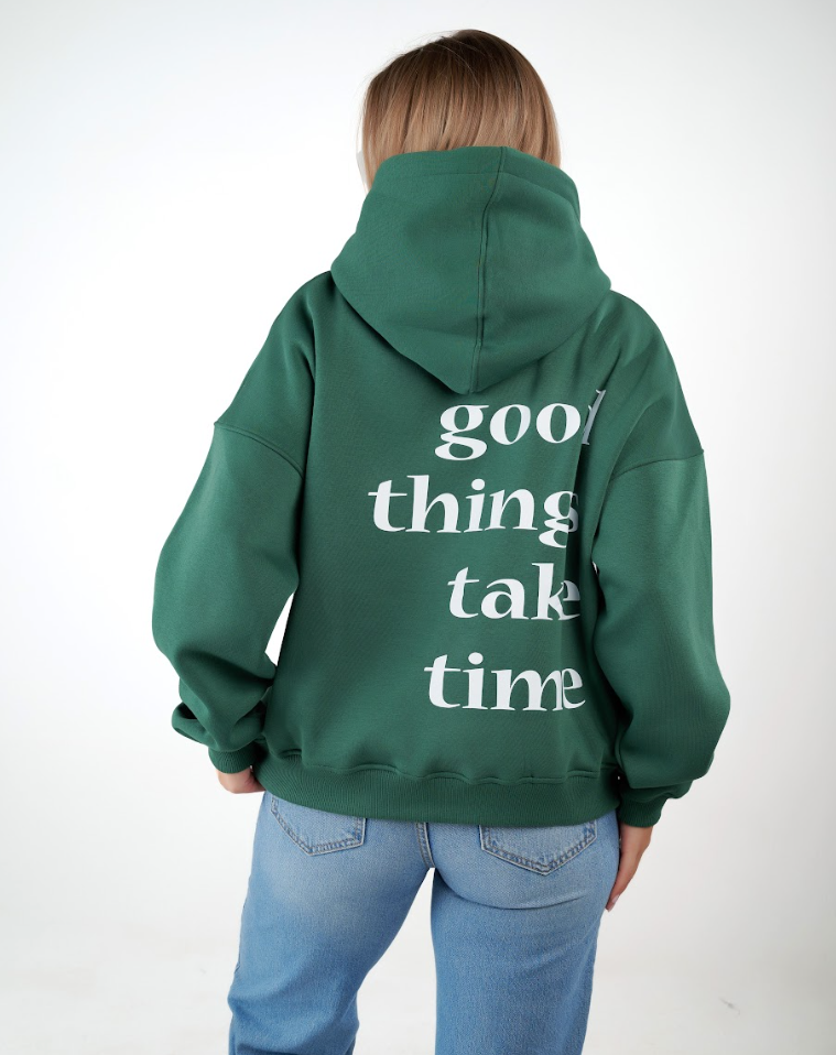 “Front logo, back inspiration — Ezi green sweatshirt.”
